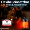 A couple sitting on a deck at night, with a heater in the foreground. Produktbild-Vorschau