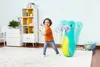 A young boy is playing with an inflatable walrus toy in a room with a bookshelf and a dresser. Produktbild-Vorschau