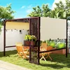 An outdoor patio scene with a pergola, seating, and plants. Podgląd zdjęcia produktu