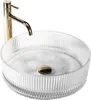 A clear glass vessel sink with a gold faucet. Anteprima dell’immagine prodotto