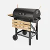 A black charcoal grill with wooden accents, shown against a plain background. Produktbild-Vorschau