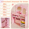 A pink children's vanity table with a mirror and various storage compartments, featuring labeled features. Voir les images du produit