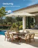 A patio dining set with a large umbrella, situated on a patio next to a swimming pool. Produktbild-Vorschau