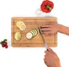 Hands chopping vegetables on a bamboo cutting board. Náhled obrázku produktu