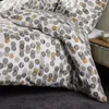 A close-up view of a duvet cover and pillowcase with a polka dot pattern. Produktbild-Vorschau