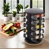 A spice rack organizer filled with spices is placed on a kitchen counter next to some fresh produce and potted plants. Podgląd zdjęcia produktu