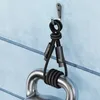 A black USB-C charging cable is hanging from a hook on a blue wall, with one end wrapped around a metal weight. Náhľad obrázku produktu