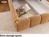 A close-up view of a corner of a bed with textured upholstery and decorative pillows, placed on a patterned rug. Produktbild-Vorschau