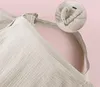 A close-up view of a beige fabric product, possibly an apron or a cover, with a detailed inset showing a metal ring and gathered fabric. Produktbild-Vorschau