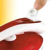 A close-up shot of a person's hand operating the water filling cap of a red and white travel iron. Produktbild-Vorschau