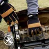 Hands wearing gloves are working on a lawn aerator. Produktbild-Vorschau