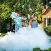 Two children are playing in a large pile of foam in a backyard. Produktbild-Vorschau