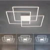 A modern, geometric LED ceiling light fixture with multiple square frames arranged in an overlapping pattern, shown against a neutral gray background. The bottom portion of the image displays the same fixture under different lighting conditions (warm, neut Anteprima dell’immagine prodotto