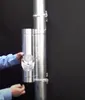 A person's hands are shown attaching a silver cylindrical component with a perforated section to a larger silver pipe. Produktbild-Vorschau