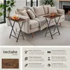 Two folding side tables are placed next to a sofa in a living room setting. Náhled obrázku produktu