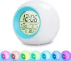 A digital alarm clock with multiple color-changing lights displayed on a white background, with a row of smaller, colored versions of the clock below. Produktbild-Vorschau