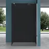 A modern walk-in shower enclosure with a black glass panel, set against a blue wall and overlooking a garden through large windows. Produktbild-Vorschau