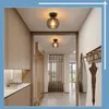 A hallway with modern wooden cabinets and two retro-style ceiling lights. Produktbild-Vorschau