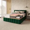A cutaway view of a mattress on a bed frame, showcasing its internal layers, in a bedroom setting. Produktbild-Vorschau