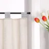 A close-up view of a window with a cafe curtain and tulips in a vase. Produktbild-Vorschau