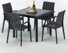 A black square table with four black chairs arranged around it, with a bottle of champagne and two glasses on a tray on the table. Produktbild-Vorschau