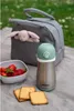 A picnic setting with a lunch bag, a water bottle, strawberries, and cookies. Podgląd zdjęcia produktu