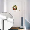 A Christmas wreath hangs on a white door in a hallway. A close-up inset shows the detail of a metal hook. Produktbild-Vorschau