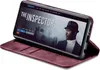 A smartphone in a burgundy flip case, displaying a movie poster for 'The Inspector'. Produktbild-Vorschau