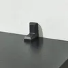 A black corner bracket on a black surface against a white textured wall. Náhled obrázku produktu