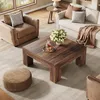 A living room scene with a coffee table, sofa, armchair, and ottoman. Voir les images du produit