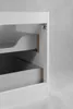 Close-up view of the interior of a white cabinet, showing drawer slides and unfinished wood edges. Náhled obrázku produktu
