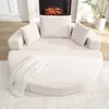 A cream-colored modular sofa with cushions is arranged in a semi-circular shape in front of a fireplace. Náhled obrázku produktu