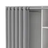 A close-up view of a light gray curtain with grommets hanging from a white curtain rod, next to a white shelving unit. Produktbild-Vorschau