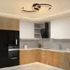 A modern kitchen with wooden cabinets, white upper cabinets, and a black refrigerator and oven. Náhled obrázku produktu