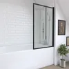 A modern bathroom with a bathtub and a glass shower screen. Anteprima dell’immagine prodotto