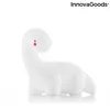 A white dinosaur-shaped night light with red and black facial features, set against a white background. Voir les images du produit