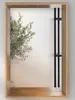 A wall mirror with a wooden frame and a small shelf, featuring a plant in the background. Produktbild-Vorschau