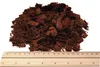A pile of coconut chips on top of a ruler. Podgląd zdjęcia produktu