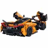 A detailed model of an orange sports car with its doors and hood open, set against a white background. Anteprima dell’immagine prodotto