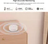 A small white sensor device is placed on a wooden surface, with concentric circles indicating its monitoring range. Voir les images du produit