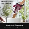 A hand is emptying the dustbin of a vacuum cleaner into a large white bin. Produktbild-Vorschau