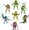 A collection of action figures, including Teenage Mutant Ninja Turtles and other characters, arranged against a white background. Anteprima dell’immagine prodotto