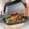 A roasted chicken with vegetables is being removed from a cast iron pot. Produktbild-Vorschau