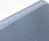 A close-up view of the top edge of a gray graphic tablet, showing a row of touch-sensitive buttons with icons. Produktbild-Vorschau