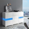 A modern white sideboard with blue LED lighting is displayed in a living room setting with a city view through a large window. Podgląd zdjęcia produktu