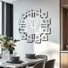 A dining room with a decorative clock on the wall and a table set for a meal. Anteprima dell’immagine prodotto
