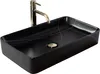 A black rectangular vessel sink with gold accents and a gold faucet. Produktbild-Vorschau