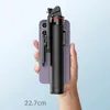 A hand holds a smartphone with a black selfie stick attached, against a light blue background. Anteprima dell’immagine prodotto