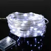 A coiled string of white LED lights with a battery pack. Produktbild-Vorschau