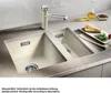A double kitchen sink with a faucet, a slice of quiche, and a bottle of oil on a countertop. Anteprima dell’immagine prodotto